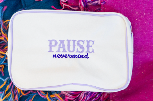 Bluebird & Co. embroidered Mahjong tile bag with colorful floral embroidery and secure drawstring closure.