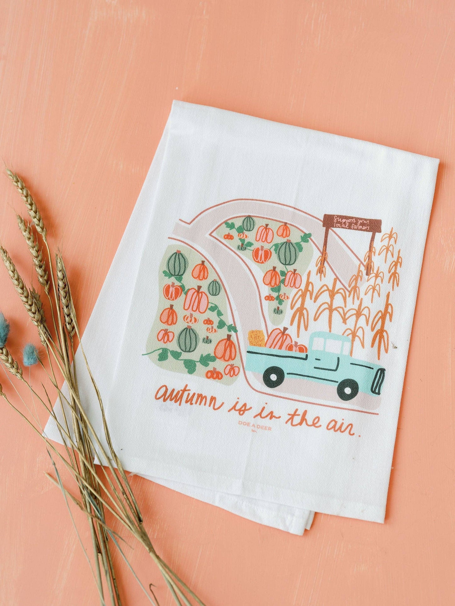 Doe A Deer Autumn is in the Air Flour Sack Towel featuring fall-themed design and soft fabric, ideal for kitchen decor and baking.