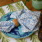Set of four Christina Dickson Home Whimsy Floral Napkins in Sorrento Blue with colorful floral patterns, perfect for table settings.
