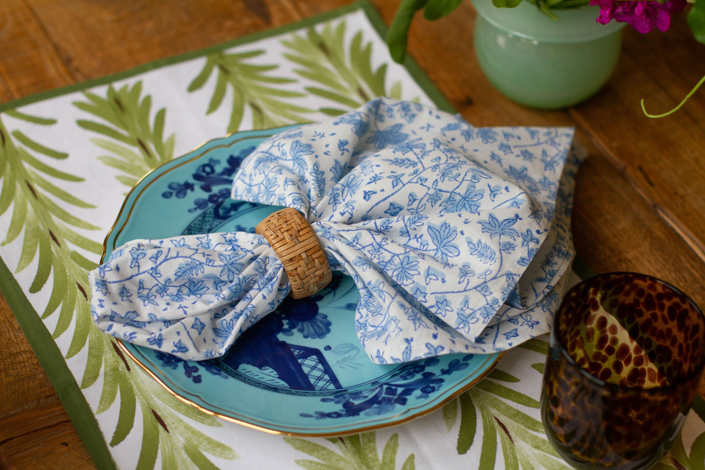 Set of four Christina Dickson Home Whimsy Floral Napkins in Sorrento Blue with colorful floral patterns, perfect for table settings.