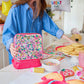 "Packed Party Audrey Jewel Confetti insulated lunch box with colorful confetti design and secure zipper closure."