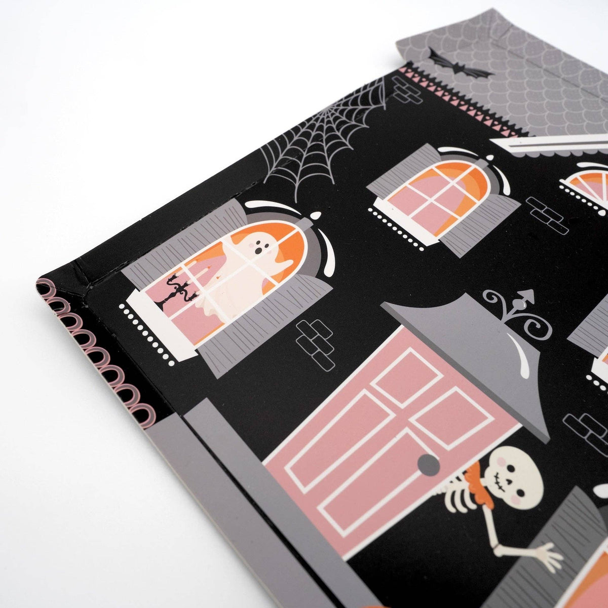 Haunted house-shaped Halloween paper plates with spooky black and orange design from Gatherings by Curated Paperie