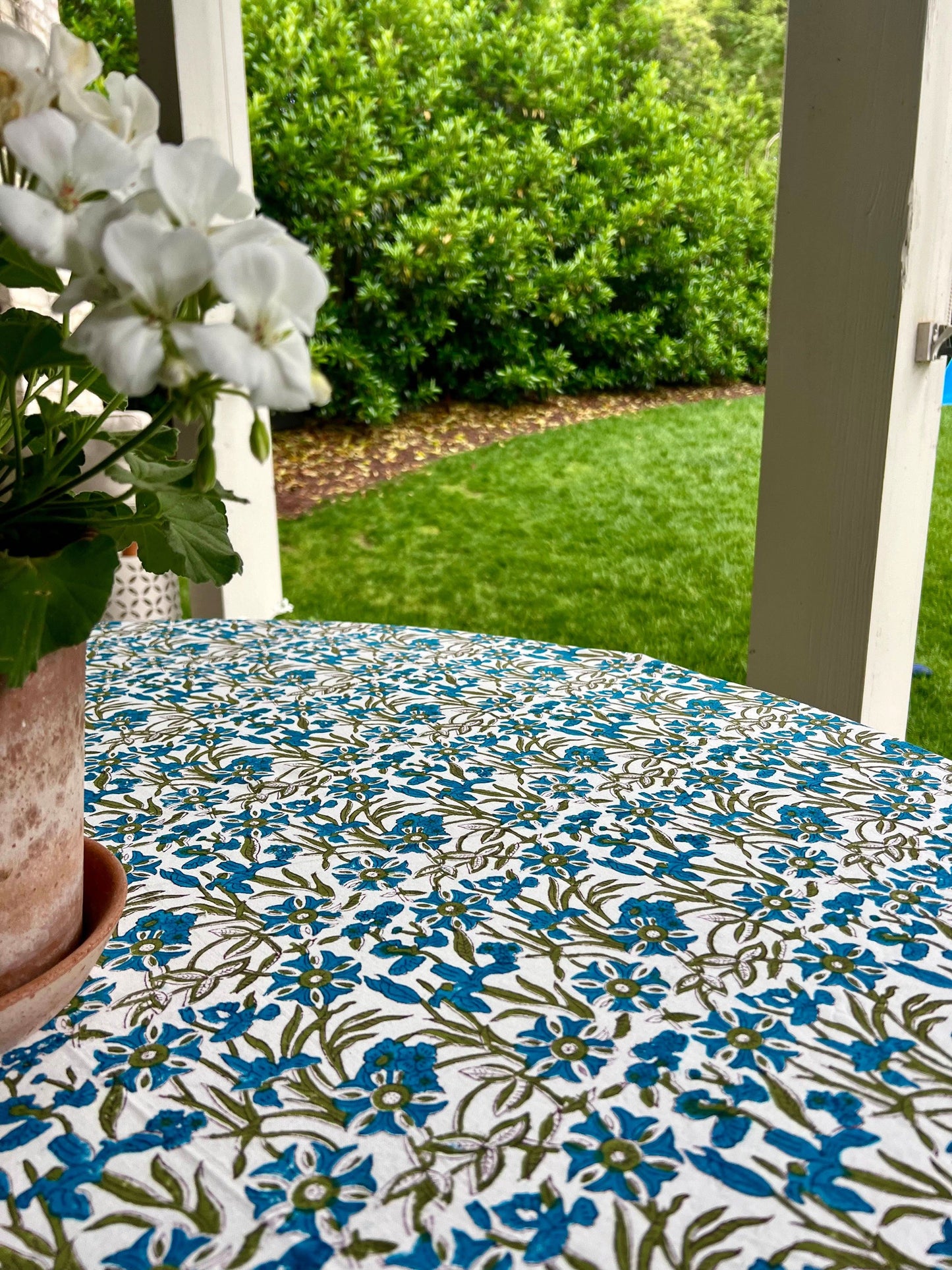 Blue Pinwheel Tablecloth by Christina Dickson Home, 120x70 inch rectangle, featuring vibrant bluebird design on fabric.