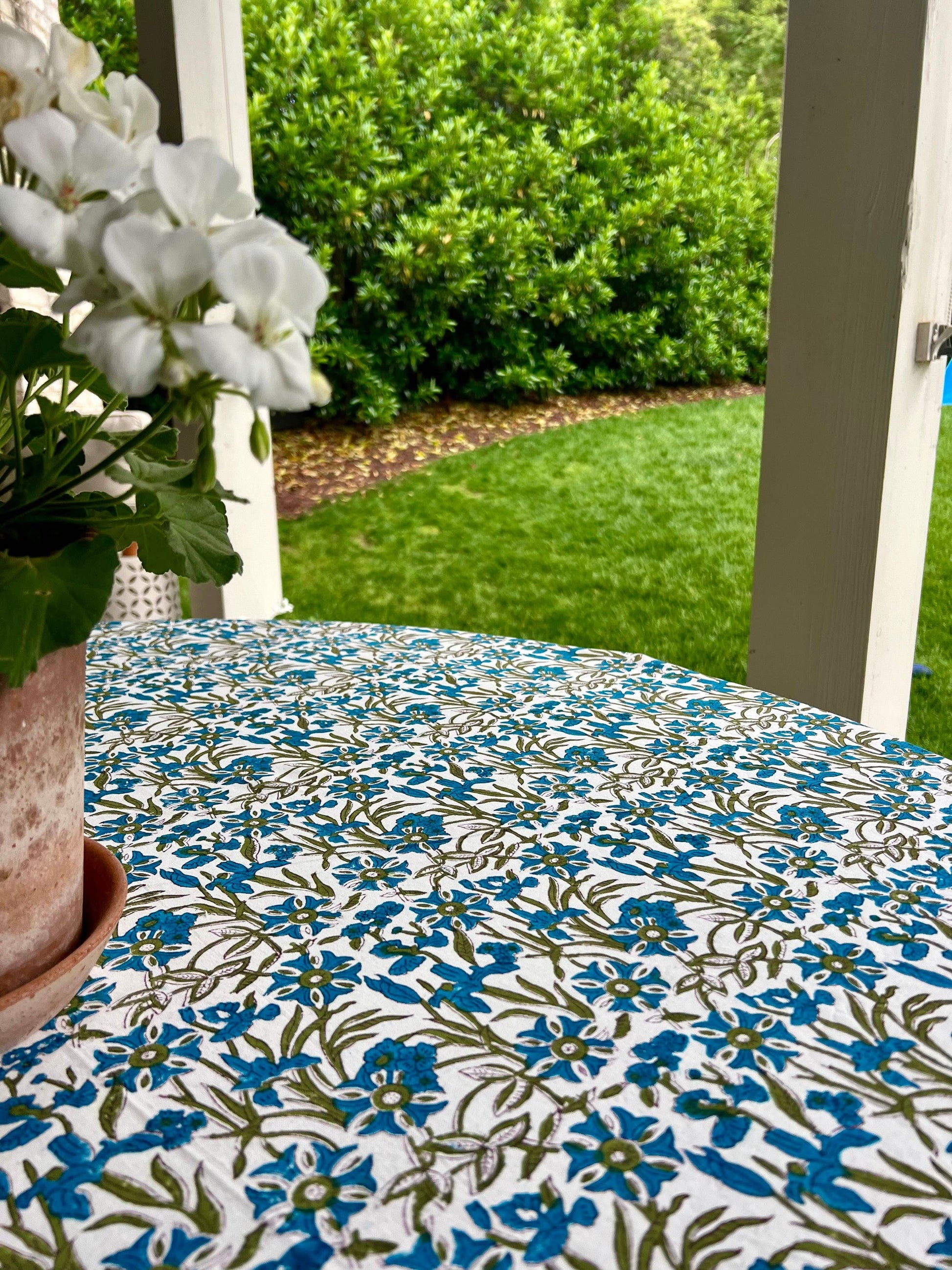 Blue Pinwheel Tablecloth by Christina Dickson Home, 120x70 inch rectangle, featuring vibrant bluebird design on fabric.