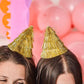 Set of four Golden Girl mini gold fringe party hats with shiny metallic finish, perfect for celebrations and festive events.