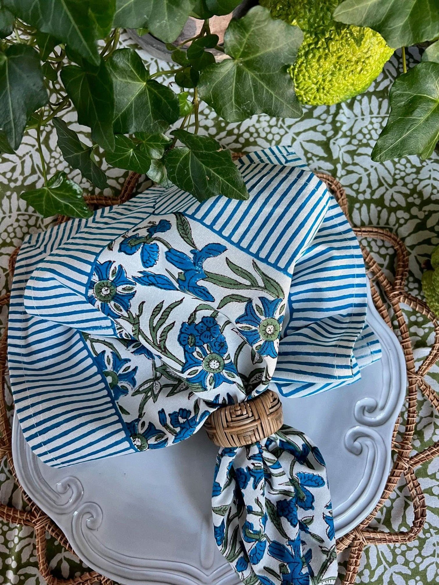 Set of four Bluebird Pinwheel Napkins by Christina Dickson Home, featuring colorful, patterned paper napkins with pinwheel design.