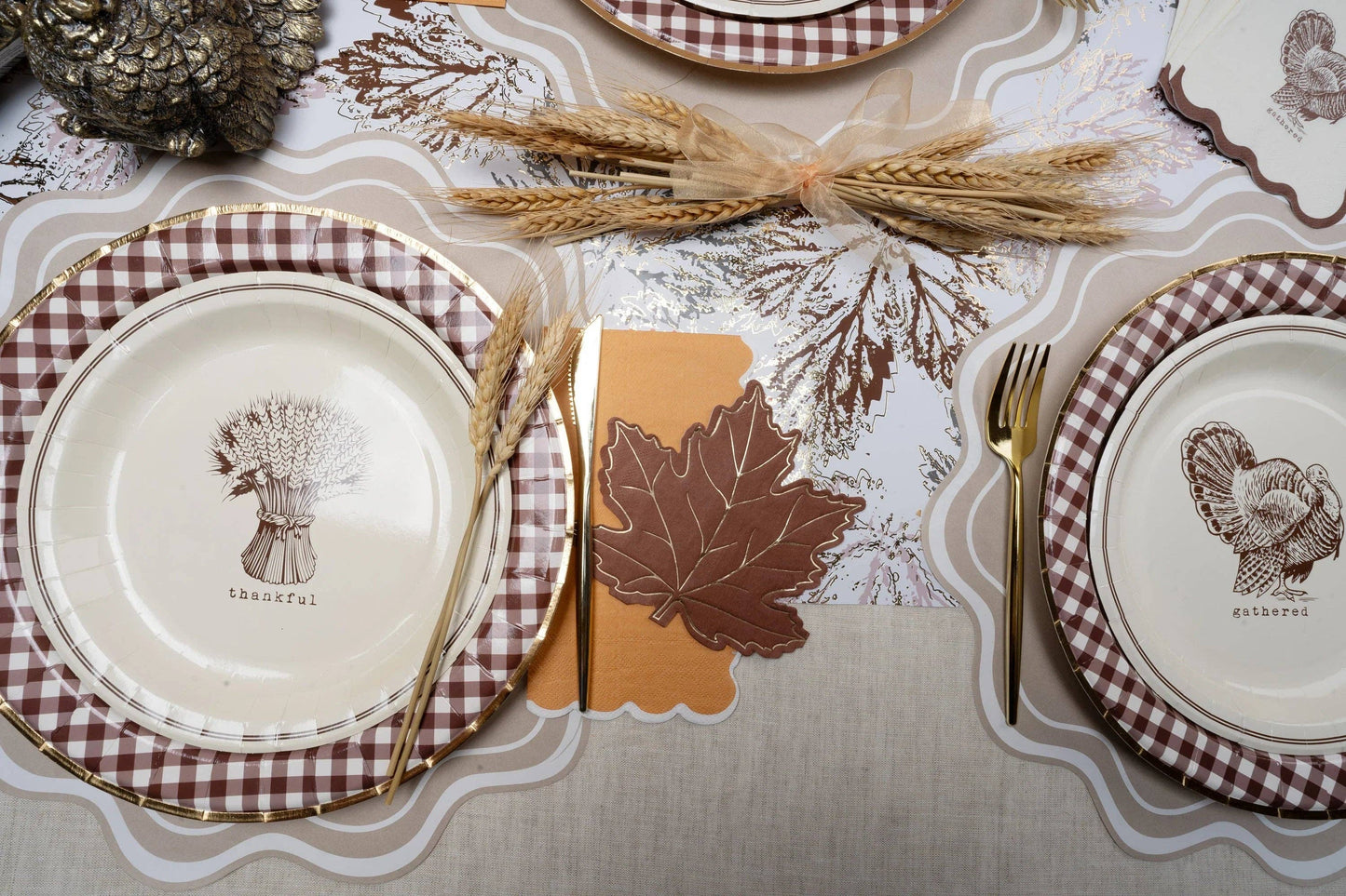 Beige wavy scallop paper placemats, 14-inch, from Gatherings by Curated Paperie, showing textured wavy edge design.