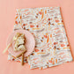 Fall-themed Flour Sack Towel with harvest and autumn full pattern from Doe A Deer, featuring vibrant fall leaf and pumpkin designs.