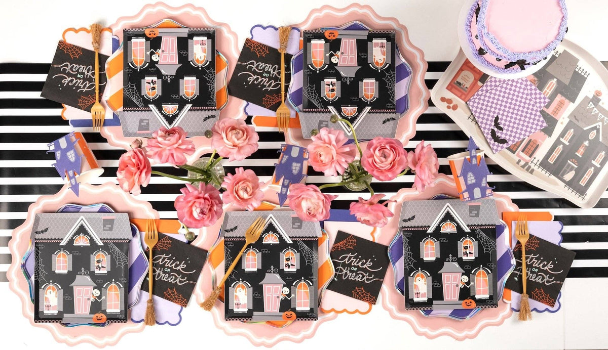 Haunted house-shaped Halloween paper plates with spooky designs from Gatherings by Curated Paperie.