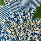 Set of four blue Pinwheel Napkins by Christina Dickson Home, featuring a colorful pinwheel pattern on soft fabric.