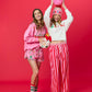 Shiraleah FA LA LA slippers in large/extra-large size, cozy and festive with red and white holiday-themed patterns.