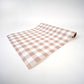 Brown gingham paper table runner by Gatherings by Curated Paperie, featuring a classic checkered pattern on lightweight paper.