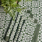 Set of 4 Feathered Tile Napkins by Christina Dickson Home with intricate feather and tile patterns in soft, elegant colors.