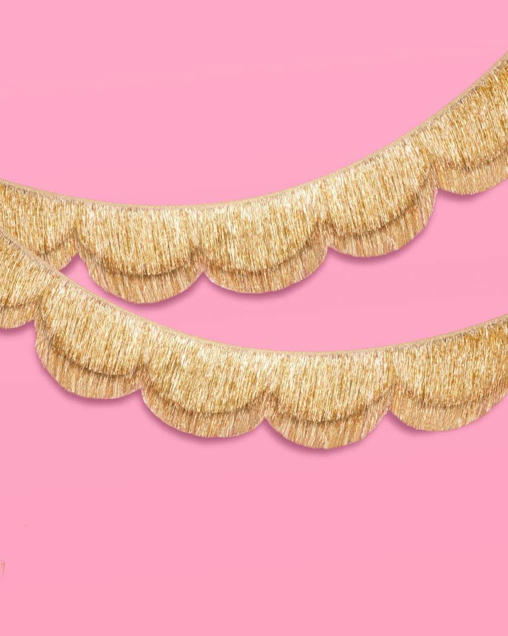 Gold scallop fringe banner by xo, Fetti featuring shimmering scalloped edges and layered gold fringe for festive decor.