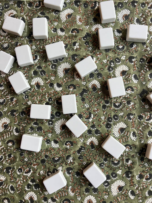 Olive Bustling Florets tablecloth by Christina Dickson Home featuring vibrant floral pattern on smooth fabric.