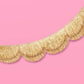 Gold scallop fringe banner by xo, Fetti featuring shimmering scalloped edges and layered fringe for festive decoration.