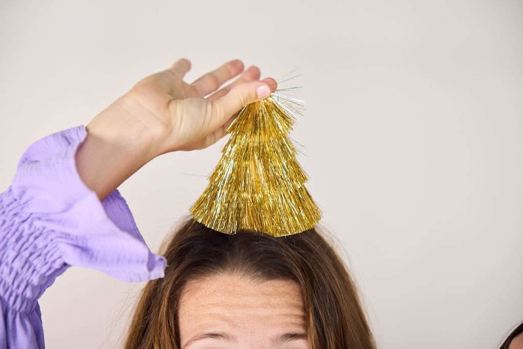 Set of four Golden Girl mini gold fringe party hats by Packed Party, featuring shiny gold fringe and festive design.