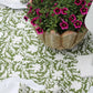 Set of four pressed floral napkins in olive green by Christina Dickson Home, featuring elegant botanical design.