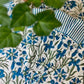 Set of four blue Pinwheel Napkins by Christina Dickson Home featuring colorful pinwheel patterns on soft fabric.